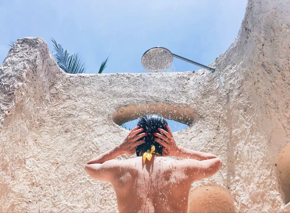Woman showering with hot water from a solar water heater