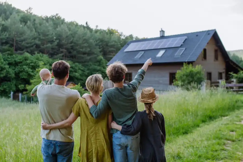 Family in front of a house with solar panels on the roof
