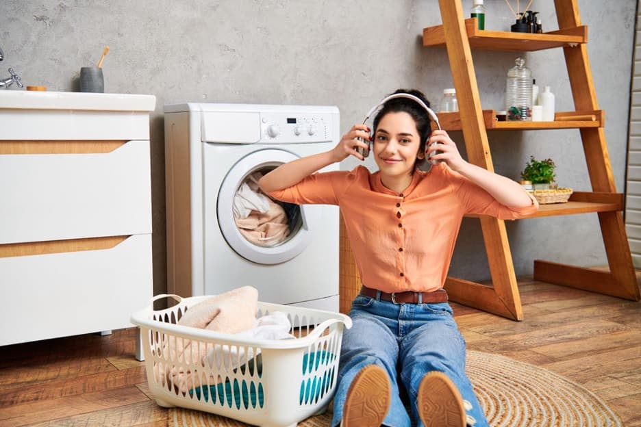 Woman loading laundry into a washing machine